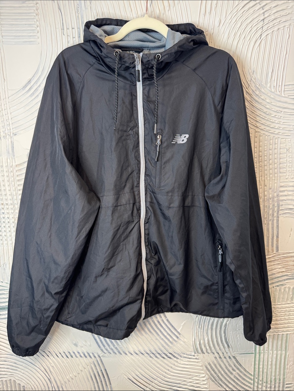 New Balance Black Hooded Windbreaker with White Trim. N0577